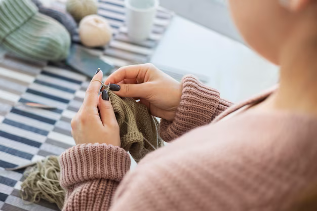 Woman knitting at home, close-up