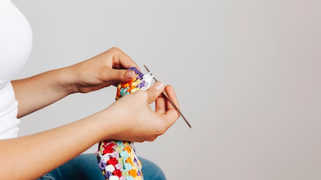 Side view of woman knitting