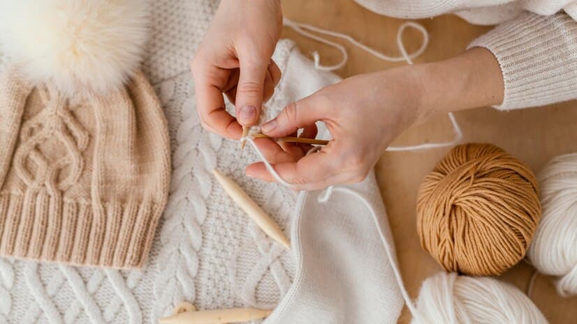 Flat Lay with Knitting Items and Knitting Hands