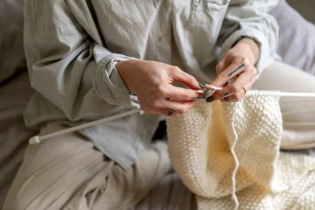 A person knits with white yarn