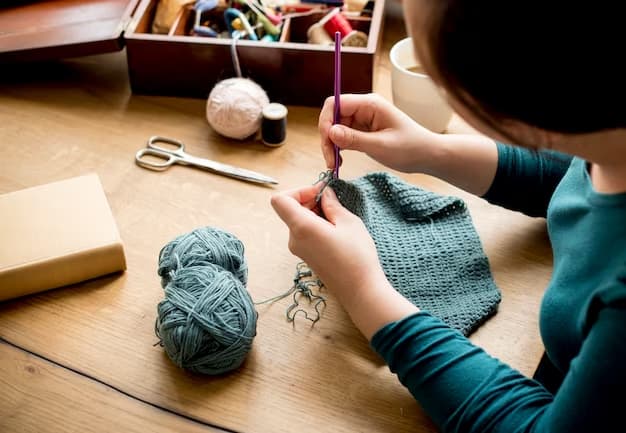 The girl in the green sweater is knitting with needles